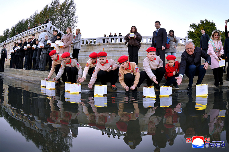 Russian schoolchildren float paper lanterns on Taedong River in Pyongyang